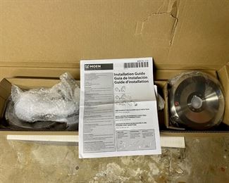 Brand new Moen shower head and faucet, still in its original packaging.