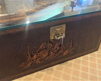 Delicately carved chest (top and front) with glass top