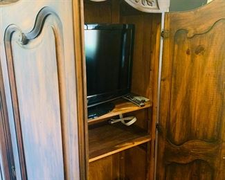 Inside of French armoire. One of four Samsung TVs for sale.