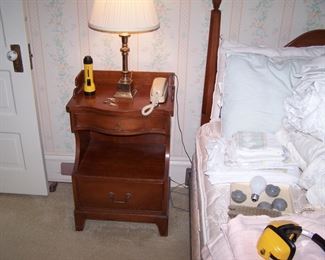 ONE OF A PAIR OF MORGANTON NIGHTSTANDS & BRASS CANDLESTICK LAMPS