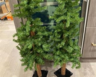 Table top Christmas trees with real wood trunks