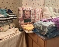 More linens, brand new quilts still in bag, comforters, beautiful fringed napkin sets