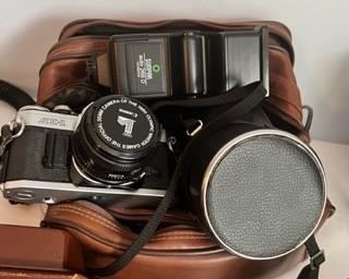 Canon AE-1 camera, mega lens, flash attachment, and leather bag. Professional grade. 
