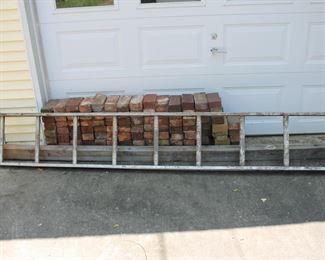 Large lot of bricks & extension ladder