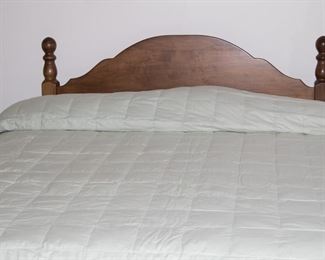 Queen bed which has been adjusted for a king mattress.