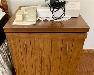 Sewing machine with cabinet