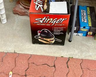 Wet/dry vac, sketchers sneakers, garden pot, white plastic lawn chairs