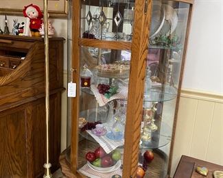 H95 - $125. Rounded glass display cabinet. Measures 36” wide x 16” deep x 66” tall. 