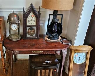 Assortment of clocks, Lamp from a Railroad lantern, oval mahogany table (elephant trunk legs) and vintage table-top radio (items sold separately)