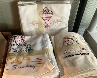 Several sets of embroidered dish towels