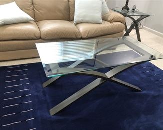 Two leather couches and blue area rug 