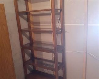 Wooden bookshelf. 5 shelves, 4 have glass bottoms. 75 x 33.5 x 14. Located in basement  (has walkout)