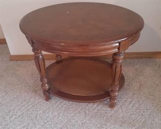 Oval shaped side table. v 20 x 27 x 22. Located in basement (has walkout)