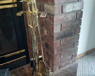 Brass fireplace tools with duck heads on handles