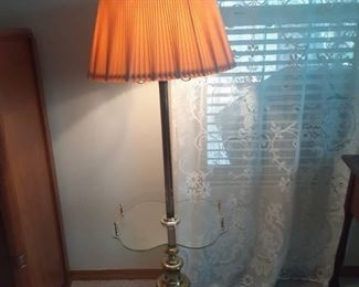 Brass lamp with glass top in middle. Glass has flowers etched on it. 55 x 17 x 14. Located in basement (has walkout)