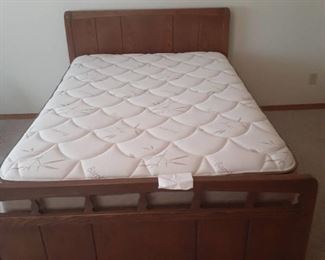 Full size bed. Headboard, footboard with side rails and a Bamboo mattress and box springs. Headboard is 41 x 55. Footboard is 26 x 55. Located in basement (has walkout)