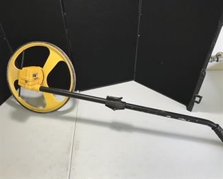 Lot # : 105 - Tools - Stanley Rolling Measurer with Handle 
clicks off distance as it rolls.
