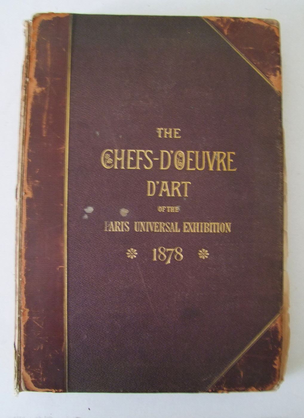 Lot # 001 1878 "Chefs - D'Oeuvre D'Art of the International Exhibition, 1878" in Paris by Edward Strahan, 250+ pages.  Leather bound, (Title translates to "Masterpieces of Art", only the title is in French). Loaded with engravings on fine heavy cotton paper throughout, 48 full page copper plate engravings, 28 full page wood engravings and 80 smaller wood engravings. There are also large images of the Paris Exhibition Buildings, 12" x 17".    Cond:  Moderate wear overall with a loose cover.  Est. $150-250