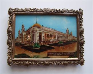 Lot 022   1904 Souvenir Reverse Glass Picture of the "Palace of Varied Industries" at World's Fair St. Louis, 1904 in a stamped brass ornate frame.  Has Mother of Pearl sections that replicates the illusion of electric lamp illumination, 5 1/4" x 7".   Cond:  Metal frame has darkened, back kick leg taped at top. Est. $40-60.  