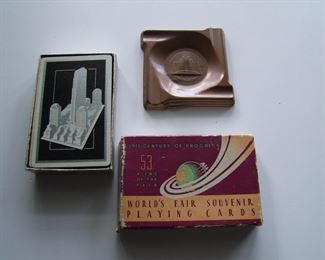 Lot 035   1933 2 Chicago World's Fair souvenir items including a boxed set of 53 playing cards and a copper ashtray measuring 3" square.  Cond:  Playing card box has moderate wear with split corners, ashtray has tiny dent but good patina.  Est. $40-60.
