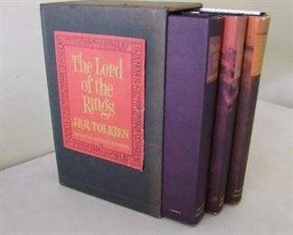 Lot 114   1965 “The Lord of the Rings” by Tolkien, 3 volumes with slip case, revised 2nd edition, all measure 6" x 9".  Cond:  Slip case has minor wear w/some fading to the spine areas of the dust jackets.  Books are mint.    Est. $200-400.