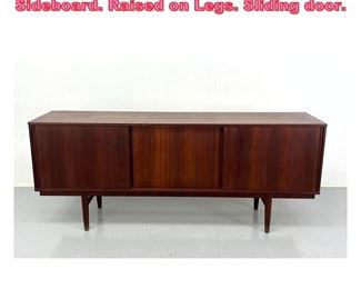 Lot 688 Danish Modern Teak Credenza Sideboard. Raised on Legs. Sliding door. 