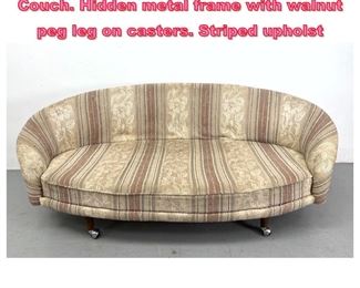 Lot 852 Modernist Curved Form Sofa Couch. Hidden metal frame with walnut peg leg on casters. Striped upholst