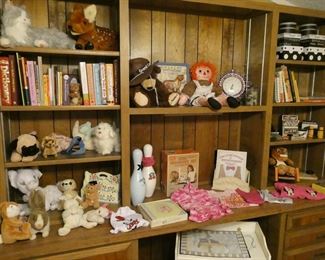 Room filled with kid's toys, books, games, and clothing.