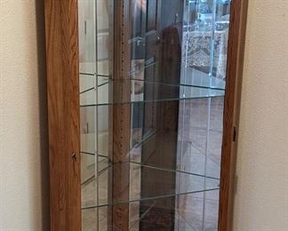 Lighted oak corner curio cabinet 