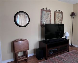 TV, entertainment center, lamps, wall decor, rug