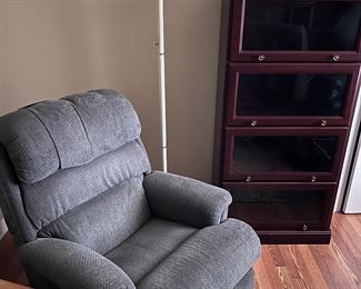 recliner chair, lamp, glass display cabinet, rug