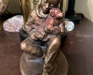 Boy hugging dog bronze figure 