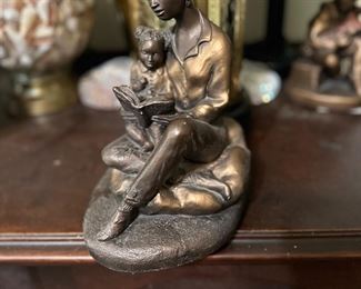 Bronze mother reading to daughter 