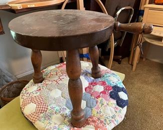 rustic three-legged stool with handle