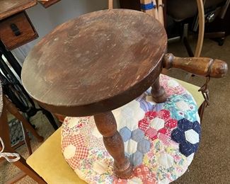 rustic three-legged stool with handle