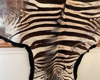 two zebra hide rugs