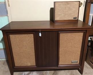 Stereo cabinet-vintage Zenith with radio, turn table and album storage.  Comes with extra portable speaker.