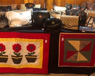 Purses including Tory Burch, several Kate Spade, Coach, the Sak, and many more.  Quilted items-the flower quilted wall hanging has been currently made & is hand quilted, hand appliqued, with sleeve on back for rod.  25" x 36 1/2".  Quilted Item--hand quilted table topper.