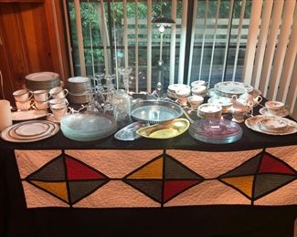 Quilted Item- Currently made table runner, hand quilted.  13 1/2'' x 53".  Glass dishes, stemmed glass ware in sets of 4,  and serving trays. (Note:  One family member wants to purchase the set of china on the far right, so it will not be available.)