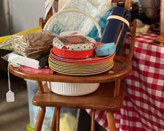 Vintage child's high chair, "Melmac" dishes, Coleman water jug, vintage canning strainer