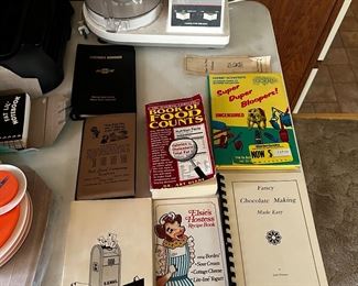 Sampling of the assortment of books: including Chevrolet Formans handbook (believed to be from the early 1960s) 1970s official US government report, Elsie the Cow recipes, 1975 Super Duper bloopers via TV shows, Fort Land Company realtors padbook with a  Jordan(JO) tele #! and more…