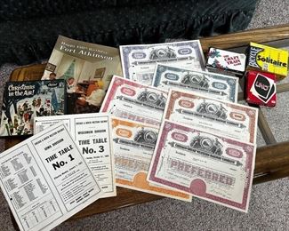 Railroad stock certificates, 1960s railroad timetables, a few games and Happy 150th Birthday Fort Atkinson magazine.