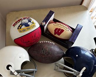 Folks!!! (take a look at the upper left-hand corner) and you’ll find a Harlem Globetrotters basketball - signed- and never used. You also have a vintage Wilson leather NFL football and a Wisconsin NIB football and a few football helmets.