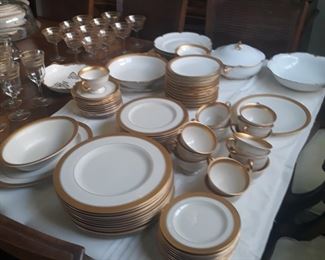 Quality fine china set with additional  serving pieces. Gold on cream color.
Service for six or twelve