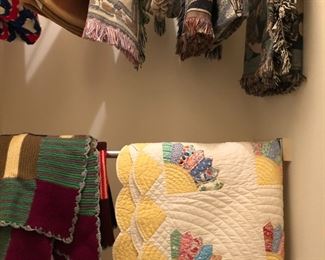 quilt, and a variety of blankets and throws
