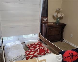 Farmhouse bed frame, side table, lamp, blankets, pillows