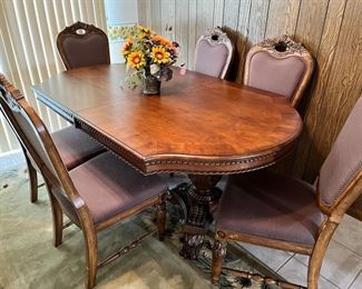 Nice carved wooden dining table with six chairs