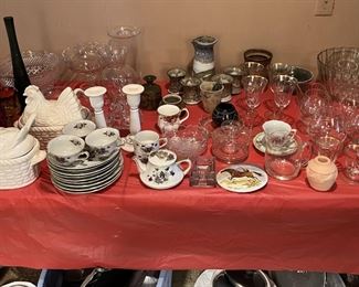 Dishware and serving-ware items can be seen in this photo.  There are other sets of similar items below the table.  Come see them all.   