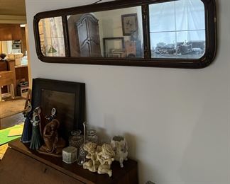 A small collection of figurines can be seen here on the secretary's desk, under the wall mirror.