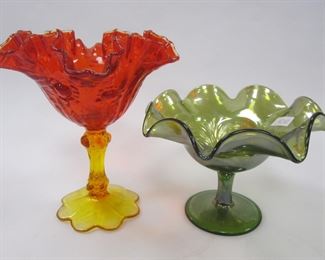 TWO FENTON GLASS COMPOTES, ONE 6.5" TALL AMBERINA, AND ONE GREEN IRRIDISED